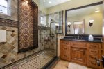 Stunning step in shower in master bath with tiles replicated from Hearst Castle 